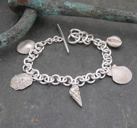 Five shell wrist chain<br>Wrist chains from £420 by Fay Page