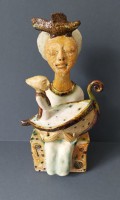 Seated figure holding a boat (SS080) by Shelagh Spear